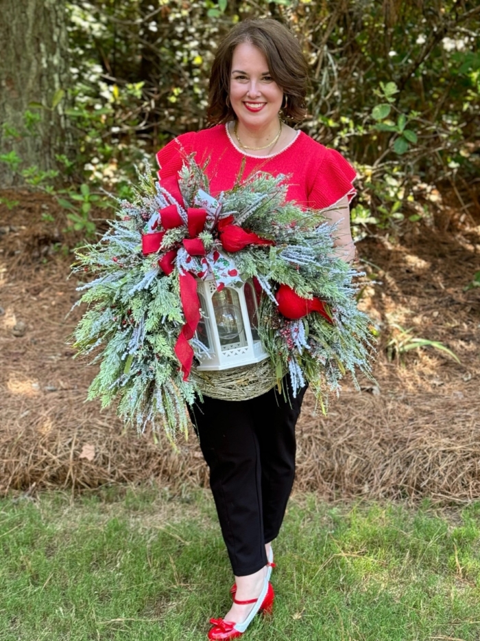 Handmade winter cardinal wreath with white lantern, frosted greenery, berries, red bow and rustic grapevine base