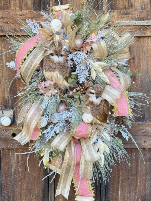 Pink and Gold Winter Owl Wreath with blush florals and gold ribbon on rustic door