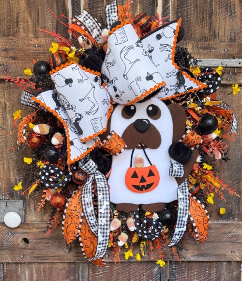 Halloween dog wrath with trick-or-treat puppy ghost and ribbons