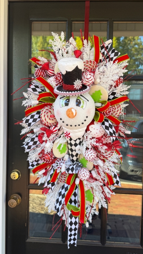 Harlequin ribbon and peppermint accents on snowman swag