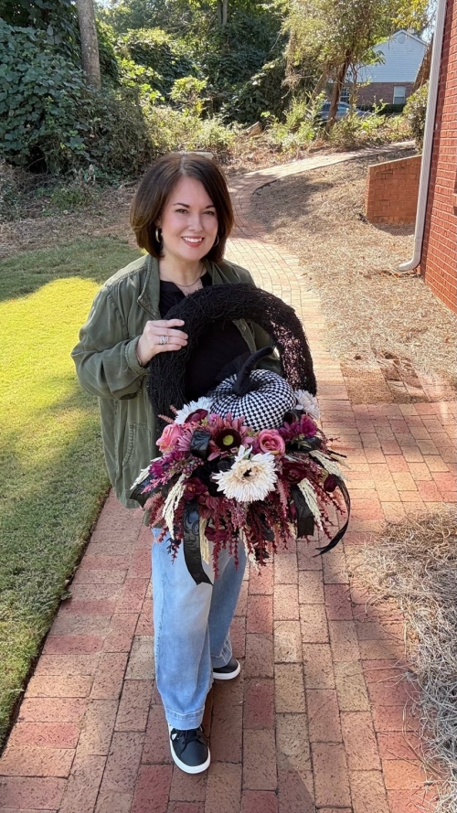 Moody Bohemian Harlequin Pumpkin Wreath held by designer