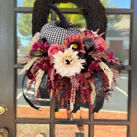 Detail of Moody Bohemian Harlequin Pumpkin Wreath with burgundy florals and harlequin pumpkin.