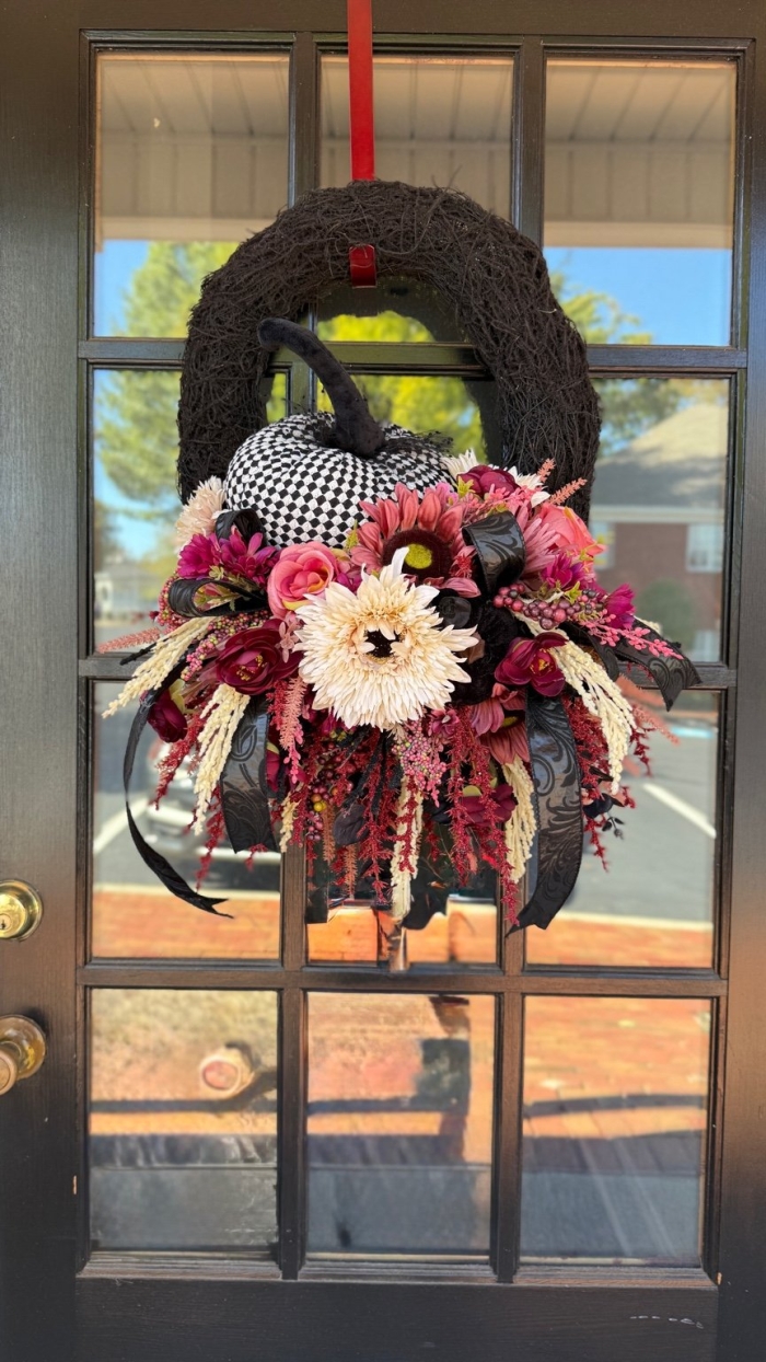 Detail of Moody Bohemian Harlequin Pumpkin Wreath with burgundy florals and harlequin pumpkin.