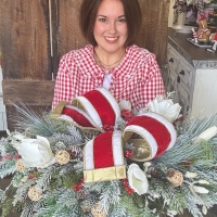 christmas evergreen centerpiece with red and white velvet bow