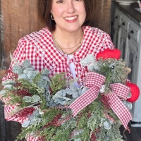 Michelle of Wisp and Wonder Designs holding the Christmas chicken wreath