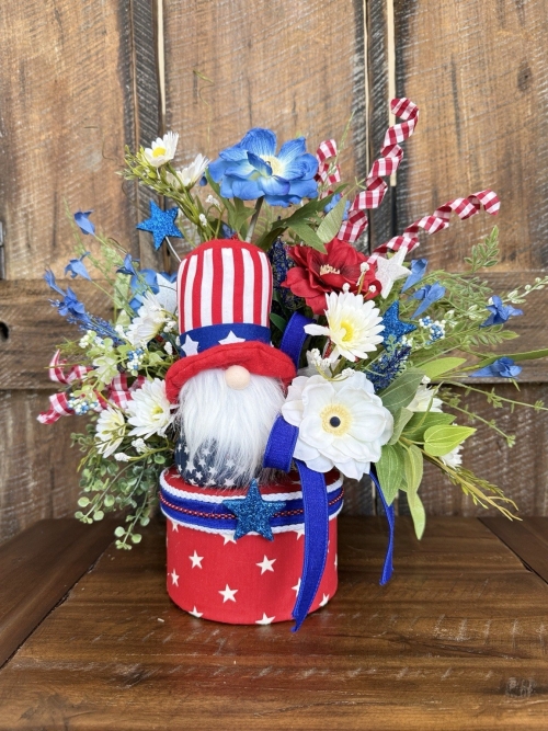 Handmade patriotic gnome centerpiece with red white and blue flowers stars and decorative container