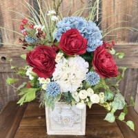 red blue white floral centerpiece with rustic drawer style container