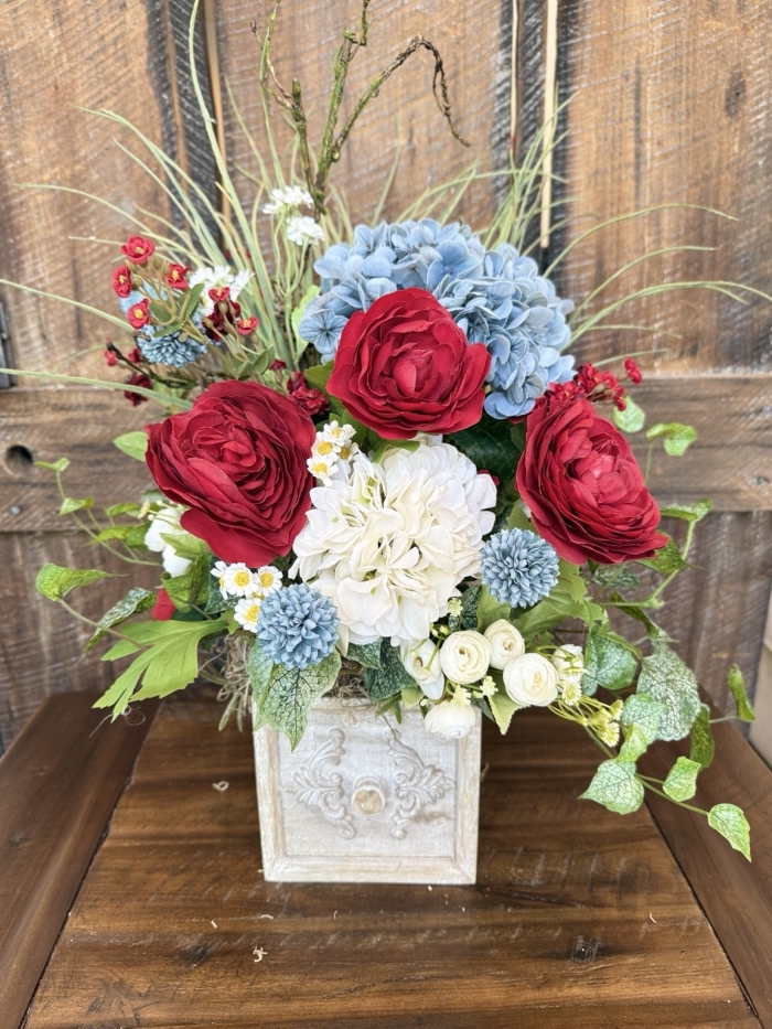 red blue white floral centerpiece with rustic drawer style container