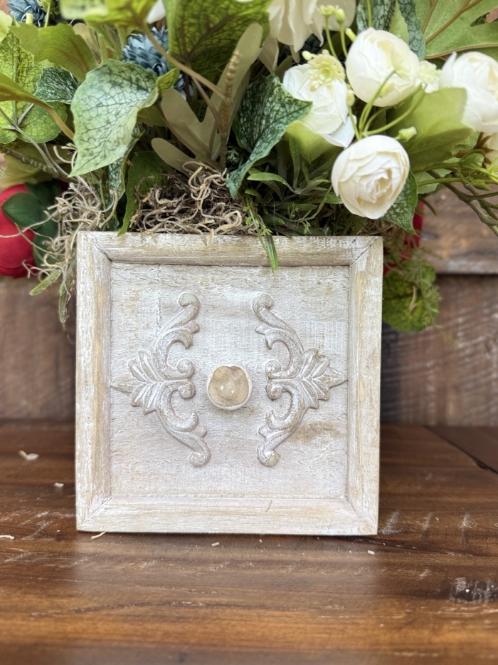 close up of neutral drawer container with floral arrangement