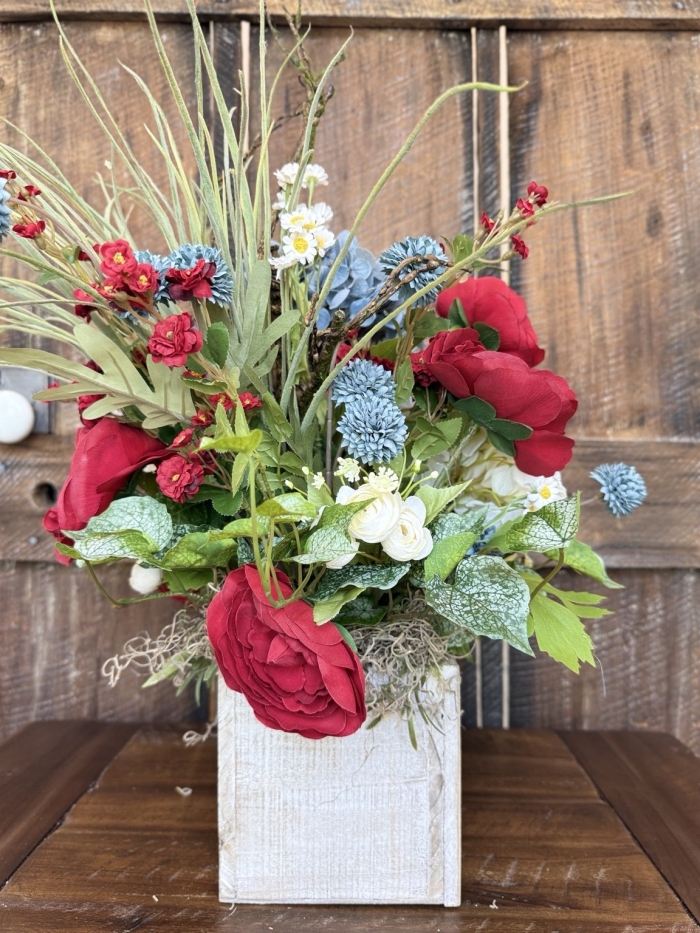 handmade red blue white centerpiece with wispy greenery