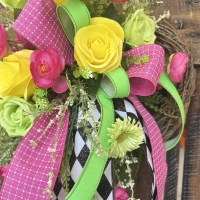 Small floral wreath with black and white harlequin ribbon and bright summer colors