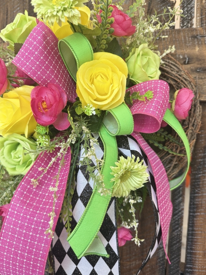 Small floral wreath with black and white harlequin ribbon and bright summer colors