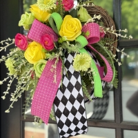 Handmade harlequin mini wreath with pink ribbon, lime green ribbon and yellow flowers