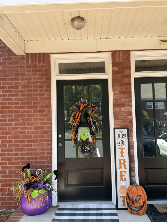 Handmade Halloween witch swag displayed on a front door with coordinating Halloween porch decor for festive seasonal decorating.