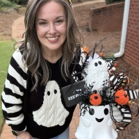 Small ghost Halloween centerpiece shown for scale with black and white ribbon, candy corn, pumpkins and whimsical ghost decor