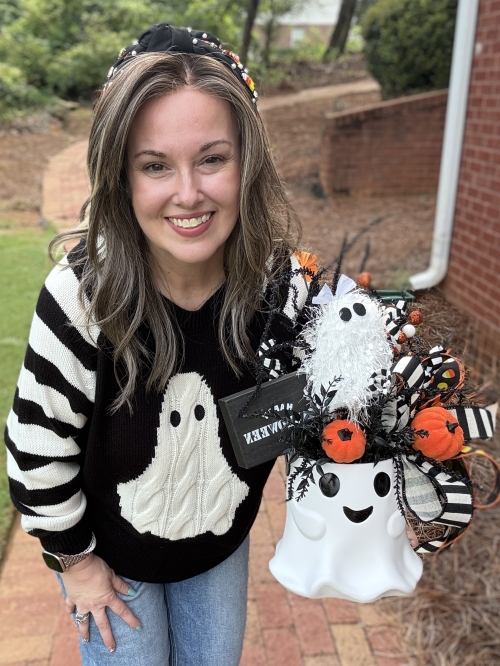 Small ghost Halloween centerpiece shown for scale with black and white ribbon, candy corn, pumpkins and whimsical ghost decor