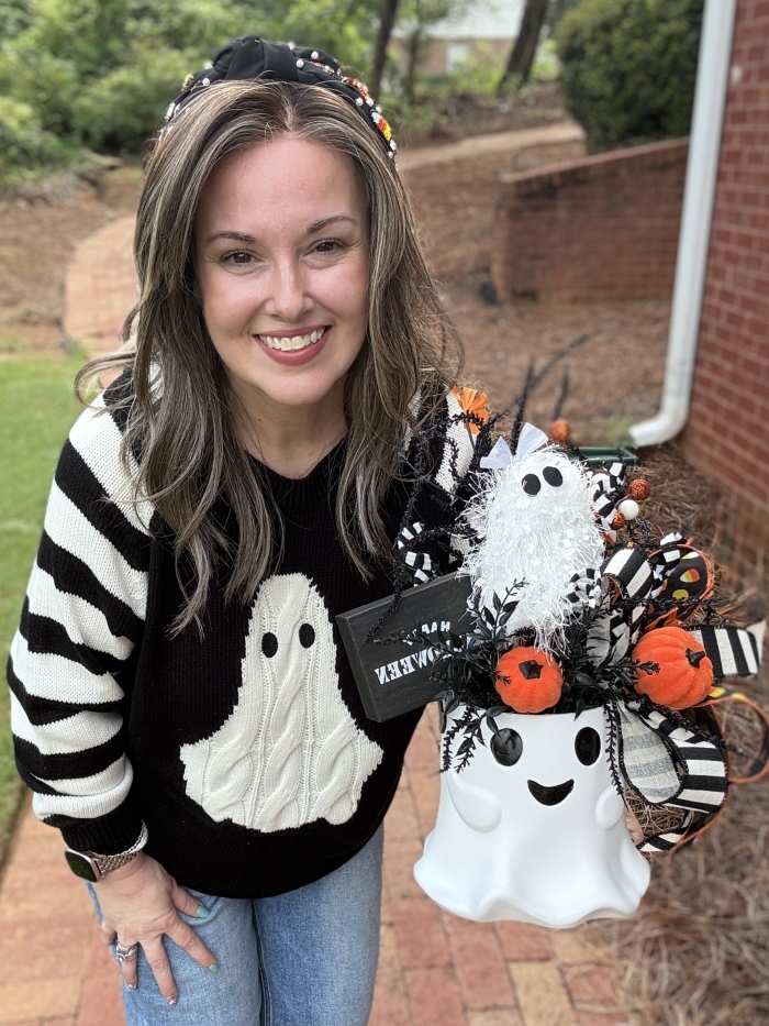 Small ghost Halloween centerpiece shown for scale with black and white ribbon, candy corn, pumpkins and whimsical ghost decor